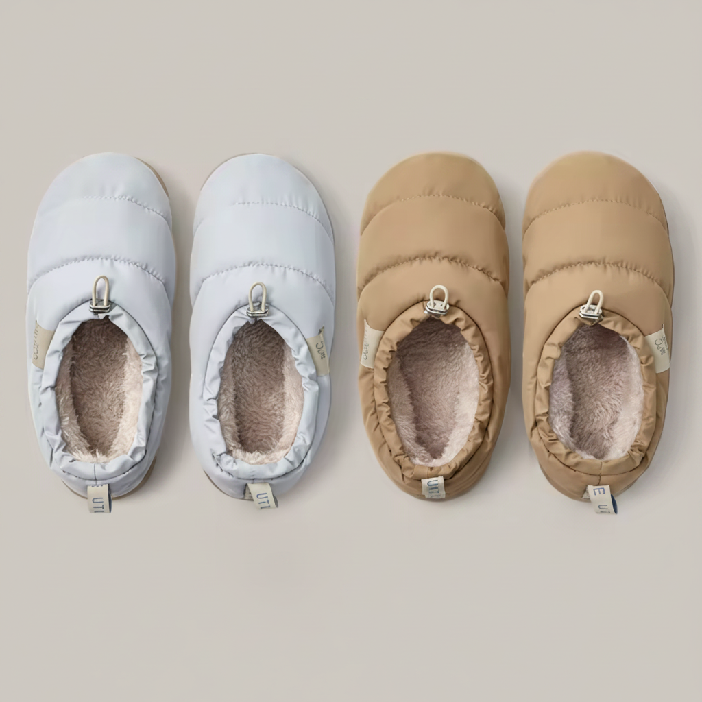 Pair of light blue and brown baby shoes on a neutral background