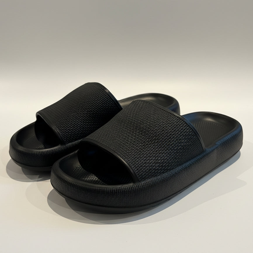 Pair of black slides on a light-colored surface