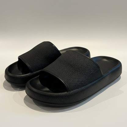 Pair of black slides on a light-colored surface