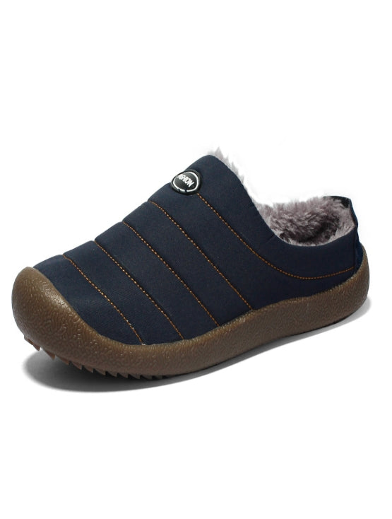 Navy blue slip-on shoe with brown sole on a white background