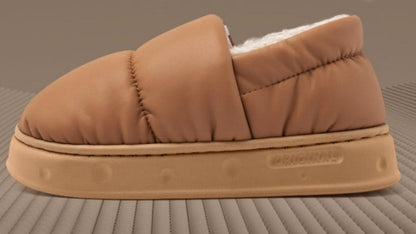 Brown slipper with a textured sole on a matching background