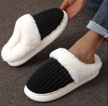 Black and white slippers with fluffy texture on a brown surface