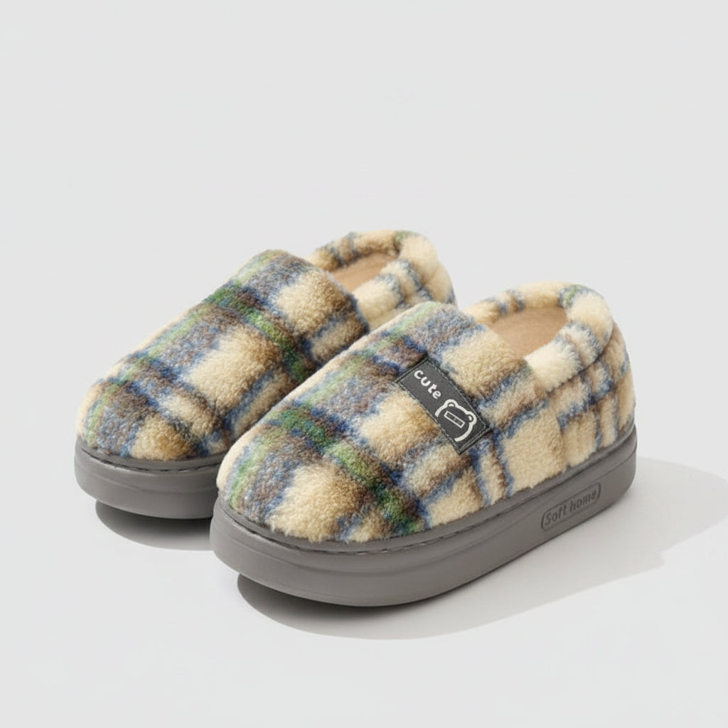 Plaid patterned slippers with 'EVA' branding on a soft surface.