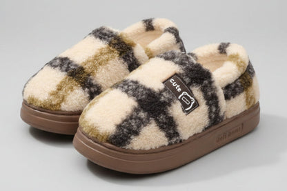 Plush and warm EVA slippers with checkered pattern on a soft surface.